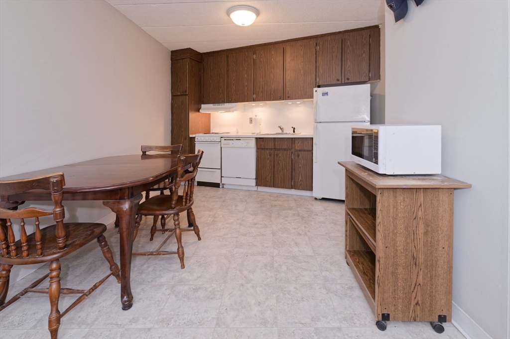 147 Turner Road, Unit 98 Holliston, MA 01746 - Photo 22 of 42 a kitchen with a sink a table and chairs