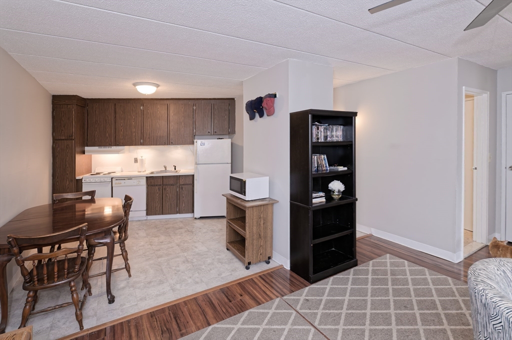 147 Turner Road, Unit 98 Holliston, MA 01746 - Photo 24 of 42 a kitchen with a refrigerator and chairs