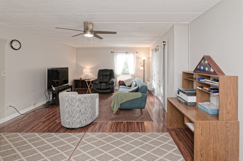 147 Turner Road, Unit 98 Holliston, MA 01746 - Photo 27 of 42 a living room with furniture and a flat screen tv
