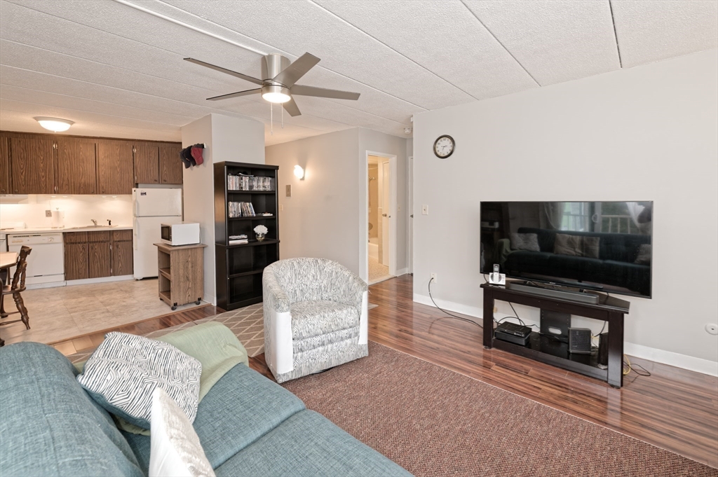 147 Turner Road, Unit 98 Holliston, MA 01746 - Photo 29 of 42 a living room with furniture and a flat screen tv