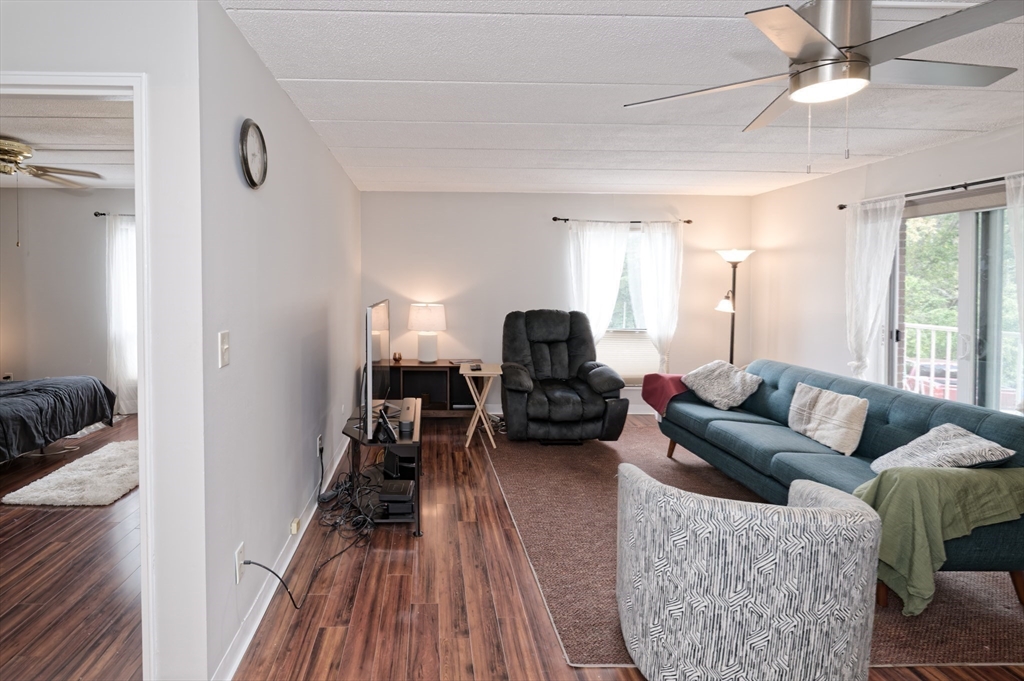 147 Turner Road, Unit 98 Holliston, MA 01746 - Photo 30 of 42 a living room with furniture and a wooden floor