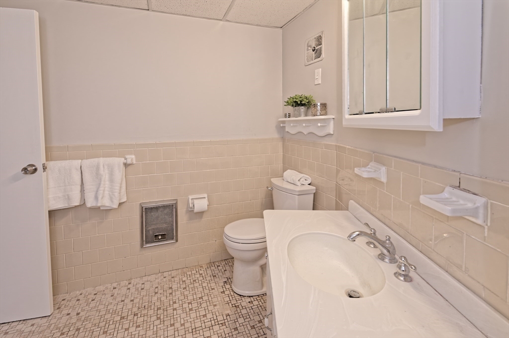 147 Turner Road, Unit 98 Holliston, MA 01746 - Photo 33 of 42 a bathroom with a sink a toilet and vanity