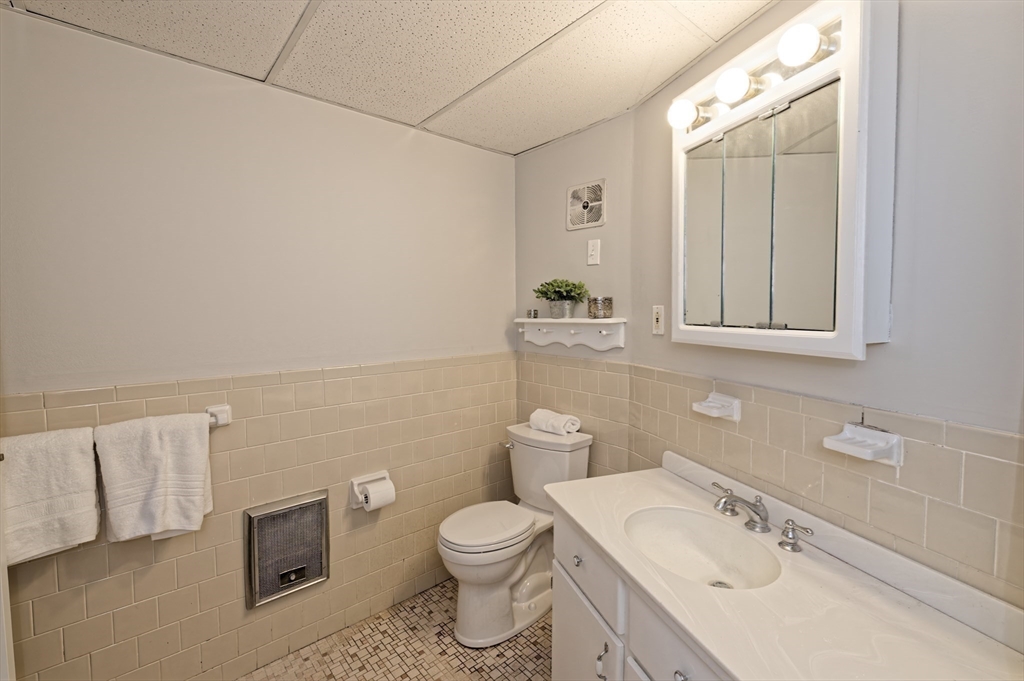 147 Turner Road, Unit 98 Holliston, MA 01746 - Photo 34 of 42 a bathroom with a sink a toilet and mirror