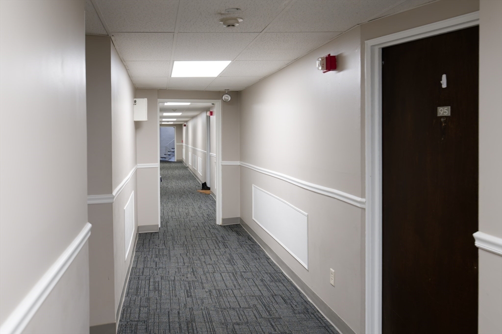 147 Turner Road, Unit 98 Holliston, MA 01746 - Photo 36 of 42 a view of hallway with wooden floor