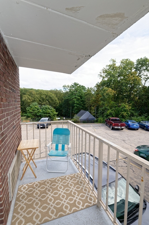 147 Turner Road, Unit 98 Holliston, MA 01746 - Photo 37 of 42 a view of balcony with wooden floor and outdoor seating