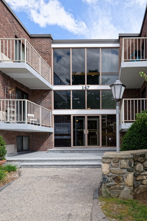 147 Turner Road, Unit 98 Holliston, MA 01746 - Photo 6 of 42 a front view of a house with a yard