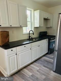 973 Monitor Road Camden, NJ 08104 - Photo 10 of 15 a kitchen with granite countertop white cabinets and stainless steel appliances