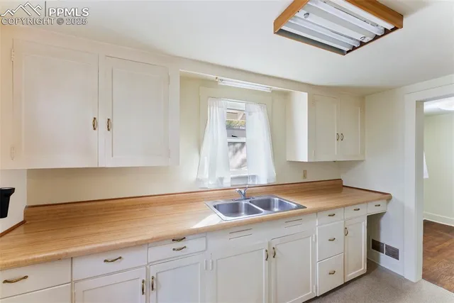 a kitchen with a sink and cabinets
