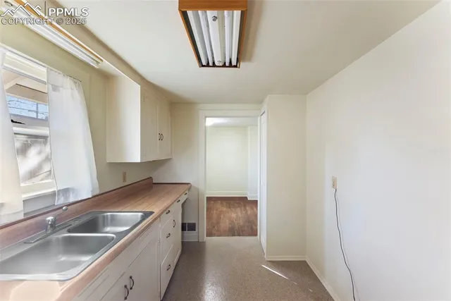 a kitchen with a sink and a refrigerator