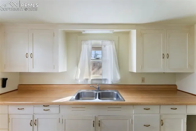 a kitchen with a sink cabinets and window