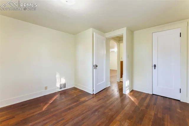 an empty room with wooden floor