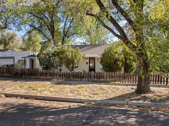 a front view of a house with a yard covered with snow