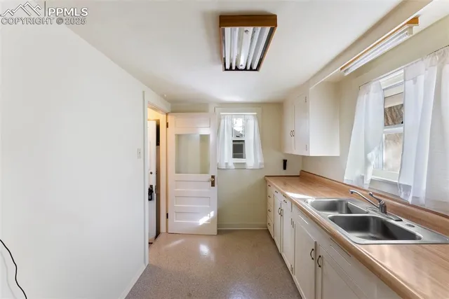 a kitchen with stainless steel appliances granite countertop a sink and a refrigerator