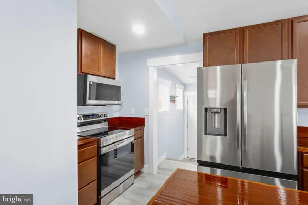 a kitchen with stainless steel appliances a refrigerator and a stove top oven