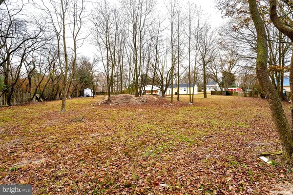 a view of kitchen with refrigerator stove dining table and chairs