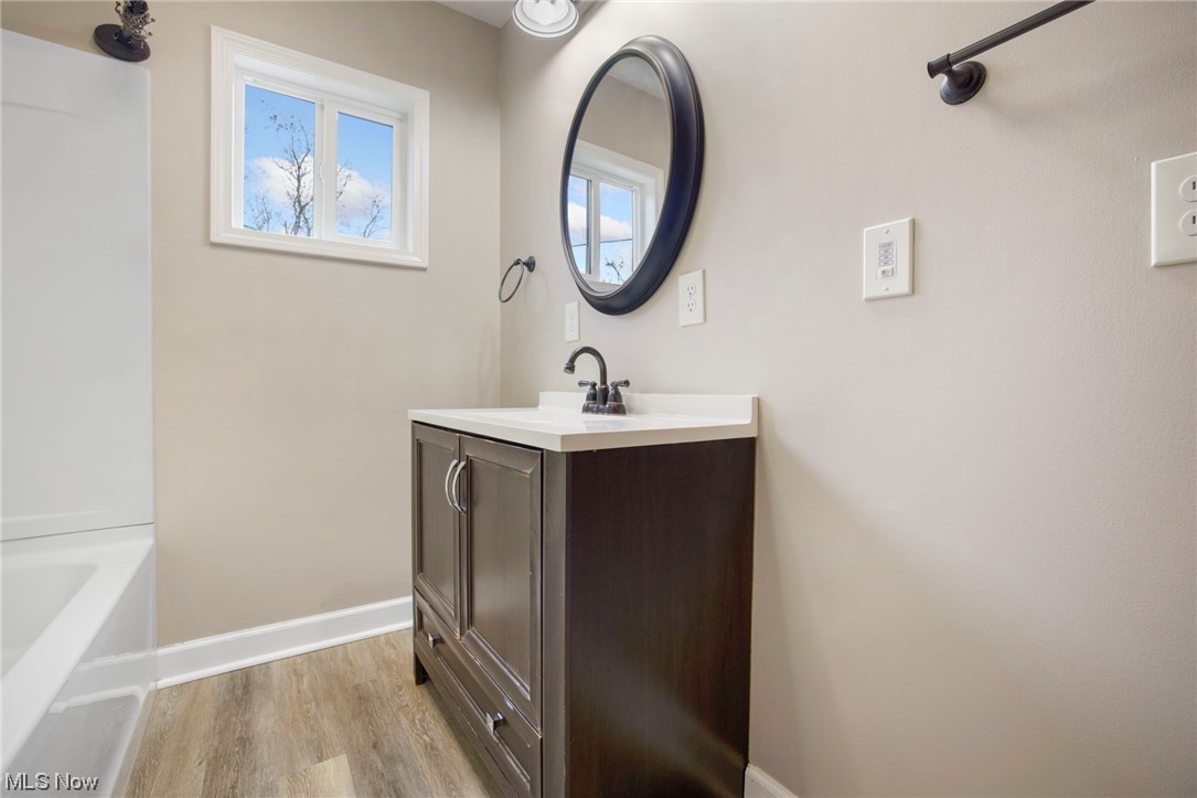 6322 Homeworth Road Homeworth, OH 44634 - Photo 13 of 36 Bathroom featuring vanity, shower / bathtub combination, and hardwood / wood-style flooring