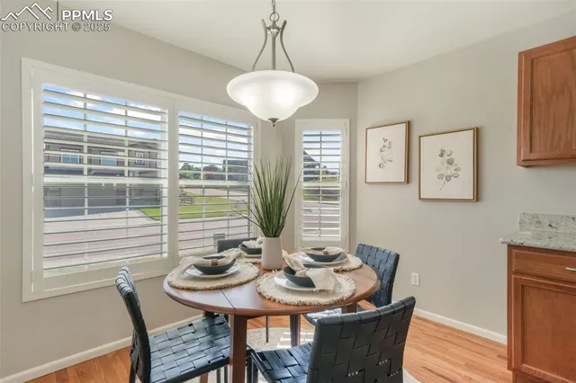 a view of a dining room with furniture window and wooden floor