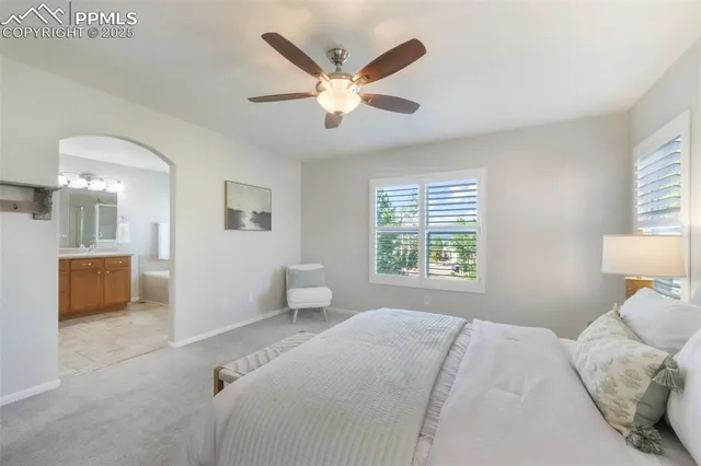 a bedroom with a large bed and a window