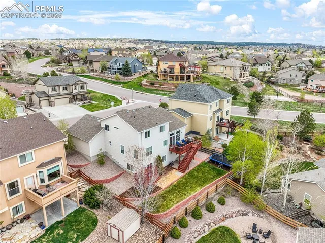 an aerial view of residential houses with outdoor space