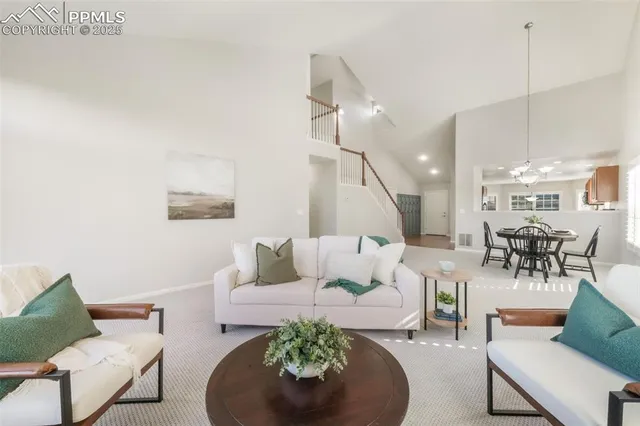 a living room with furniture and a chandelier
