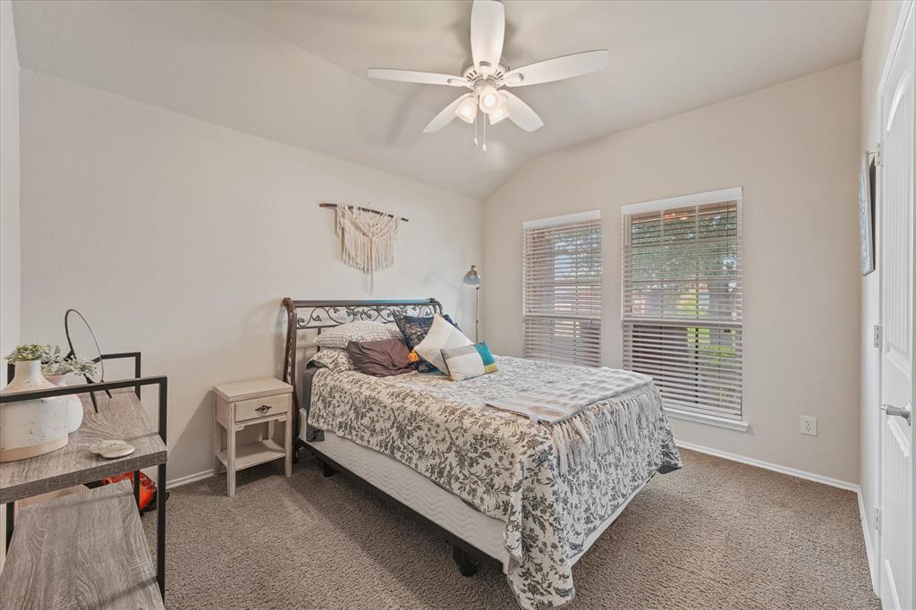 409 Harding Lane Lavon, TX 75166 - Photo 5 of 34 Carpeted bedroom featuring a vaulted ceiling with a ceiling fan