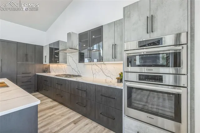 a kitchen with stainless steel appliances granite countertop a stove microwave and cabinets