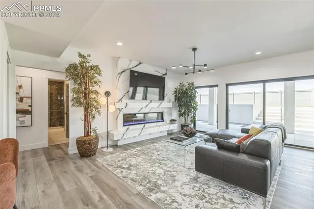 a living room with furniture and a chandelier