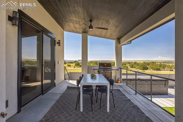 a view of a balcony with furniture and floor to ceiling window