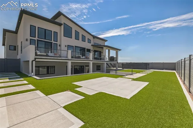 a view of an house with swimming pool and a yard