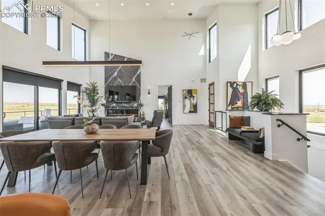 a dining hall with stainless steel appliances kitchen island granite countertop furniture and a kitchen view