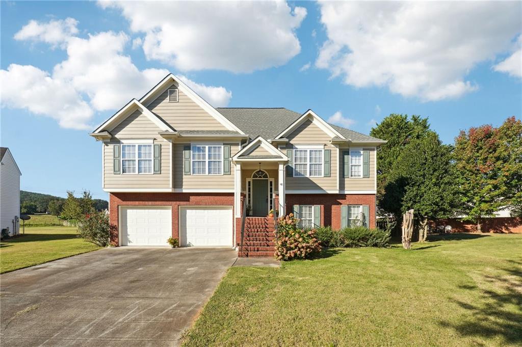 a front view of a house with a garden