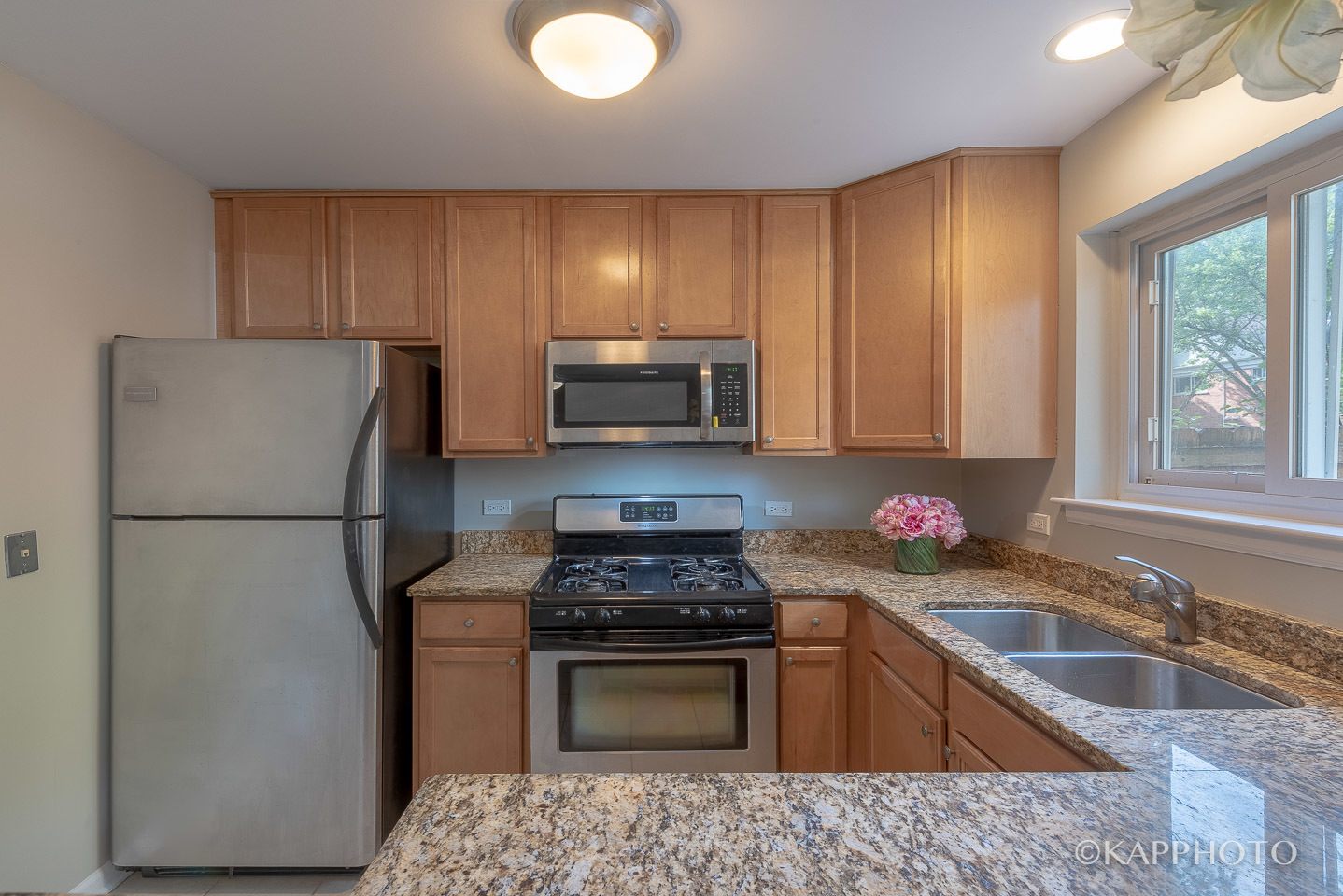 1406 Shermer Road, Unit 1406 Northbrook, IL 60062 - Photo 11 of 28 a kitchen with a refrigerator sink and stove