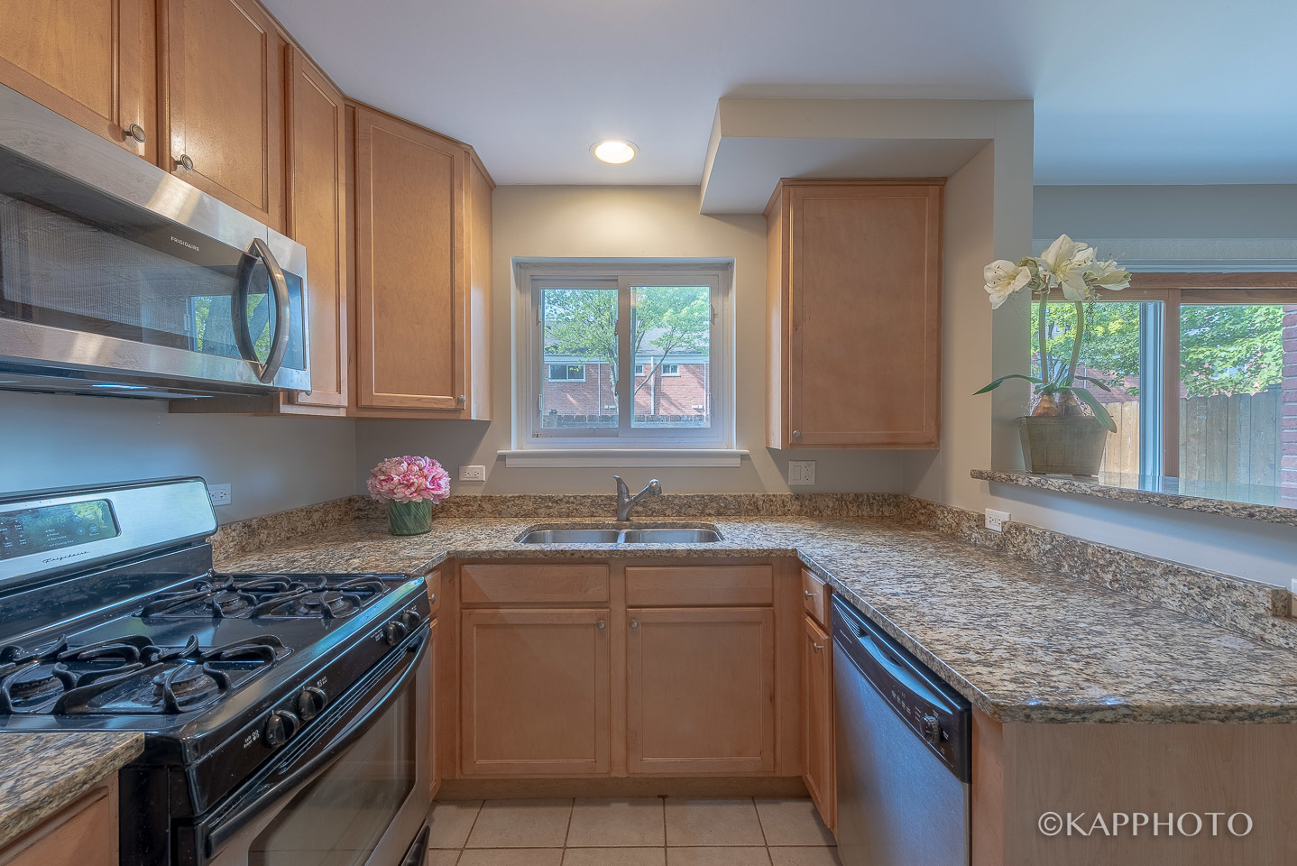 1406 Shermer Road, Unit 1406 Northbrook, IL 60062 - Photo 12 of 28 a kitchen with a sink stove top oven and cabinets