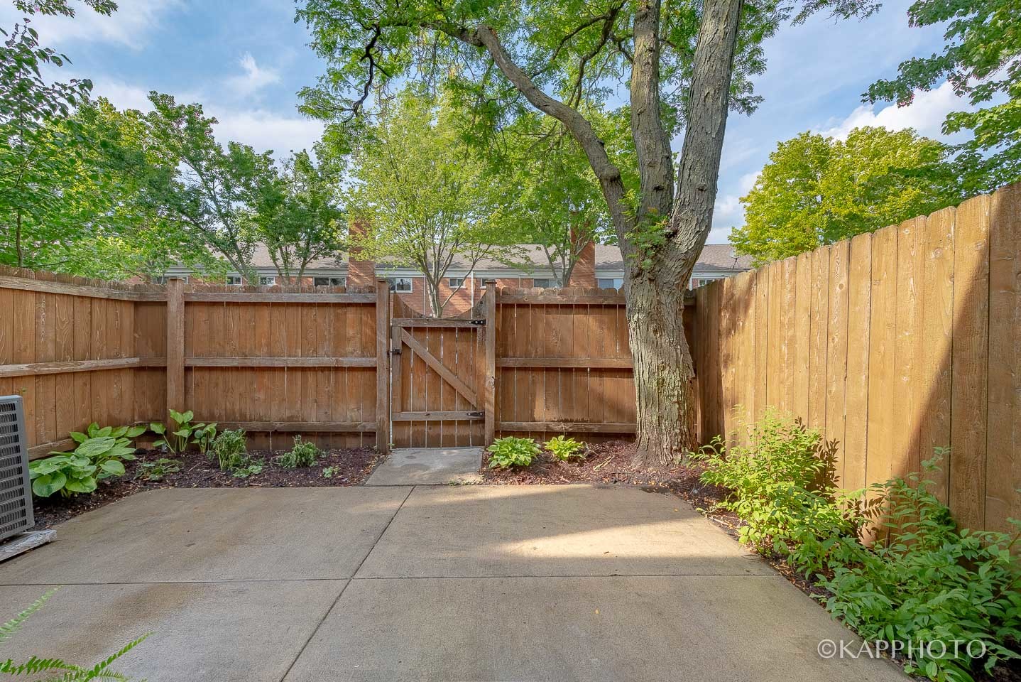1406 Shermer Road, Unit 1406 Northbrook, IL 60062 - Photo 13 of 28 front view of a house with potted plants and a bench