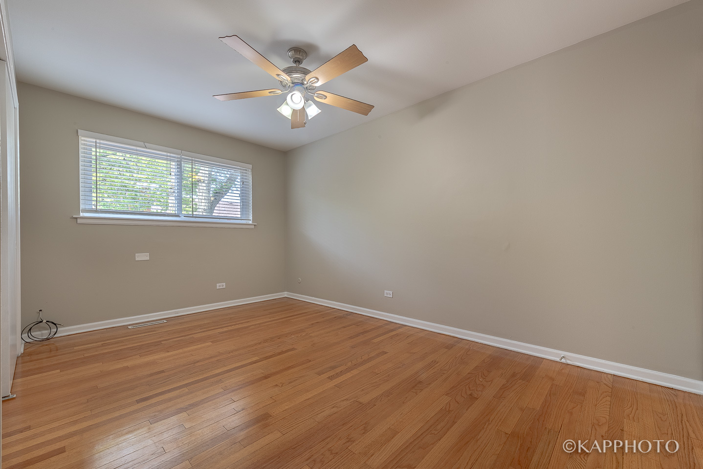 1406 Shermer Road, Unit 1406 Northbrook, IL 60062 - Photo 16 of 28 an empty room with wooden floor and chandelier fan