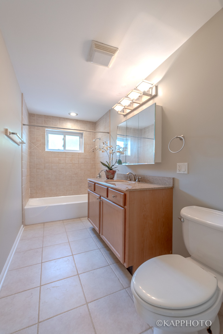 1406 Shermer Road, Unit 1406 Northbrook, IL 60062 - Photo 20 of 28 a bathroom with a sink a toilet and mirror