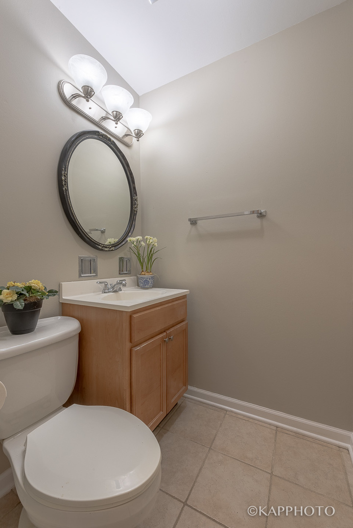 1406 Shermer Road, Unit 1406 Northbrook, IL 60062 - Photo 28 of 28 a bathroom with a toilet sink and mirror