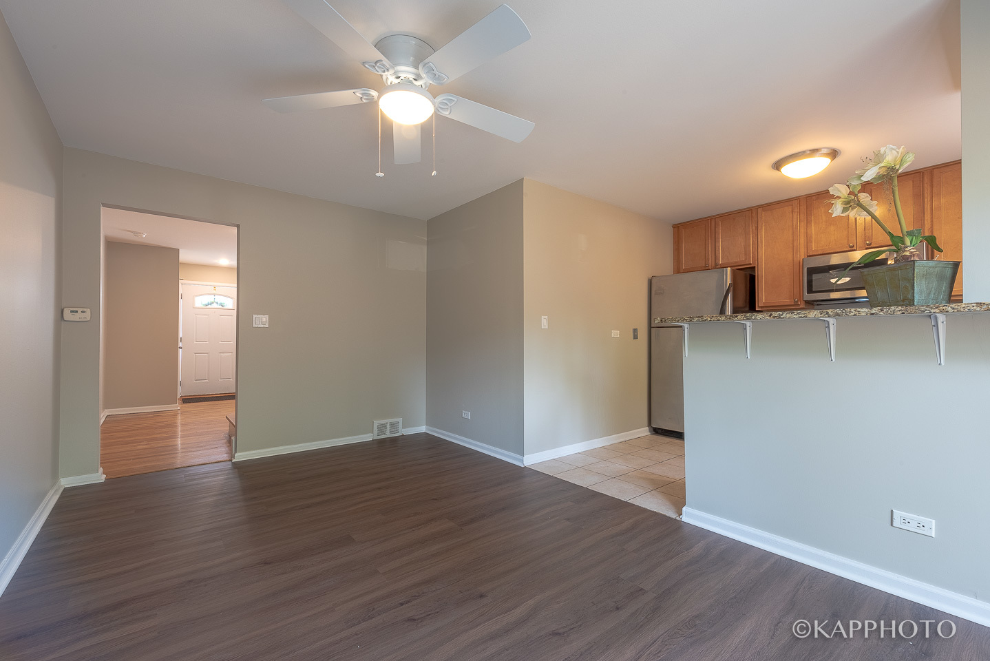 1406 Shermer Road, Unit 1406 Northbrook, IL 60062 - Photo 9 of 28 wooden floor in an empty room with a kitchen