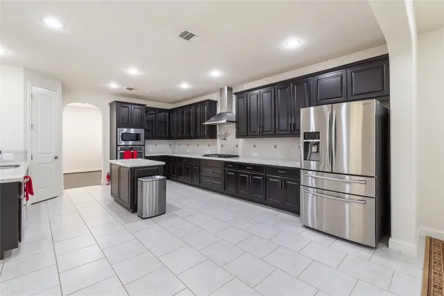 a view of a big room with windows and chandelier fan