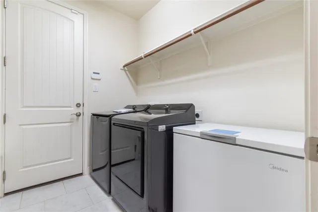 a bathroom with a tub a double vanity sink and a mirror