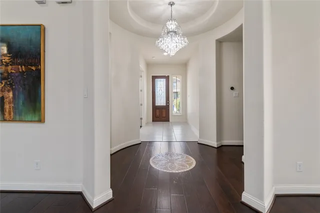 an empty room with wooden floor and ceiling fan