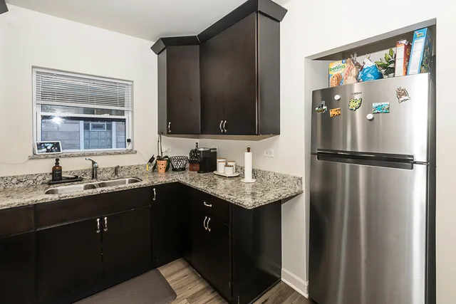 a kitchen with a sink and a refrigerator