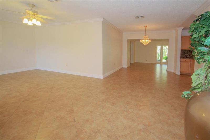 98 Seminole Lane Boca Raton, FL 33487 - Photo 14 of 42 an empty room with stairs and wooden floor