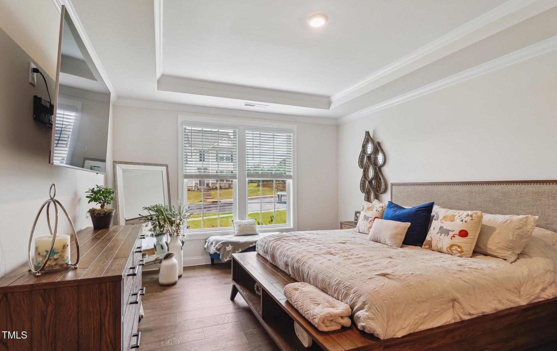 817 James J Freeland Memorial Drive Hillsborough, NC 27278 - Photo 10 of 33 a bedroom with a bed and a flat tv screen on dresser