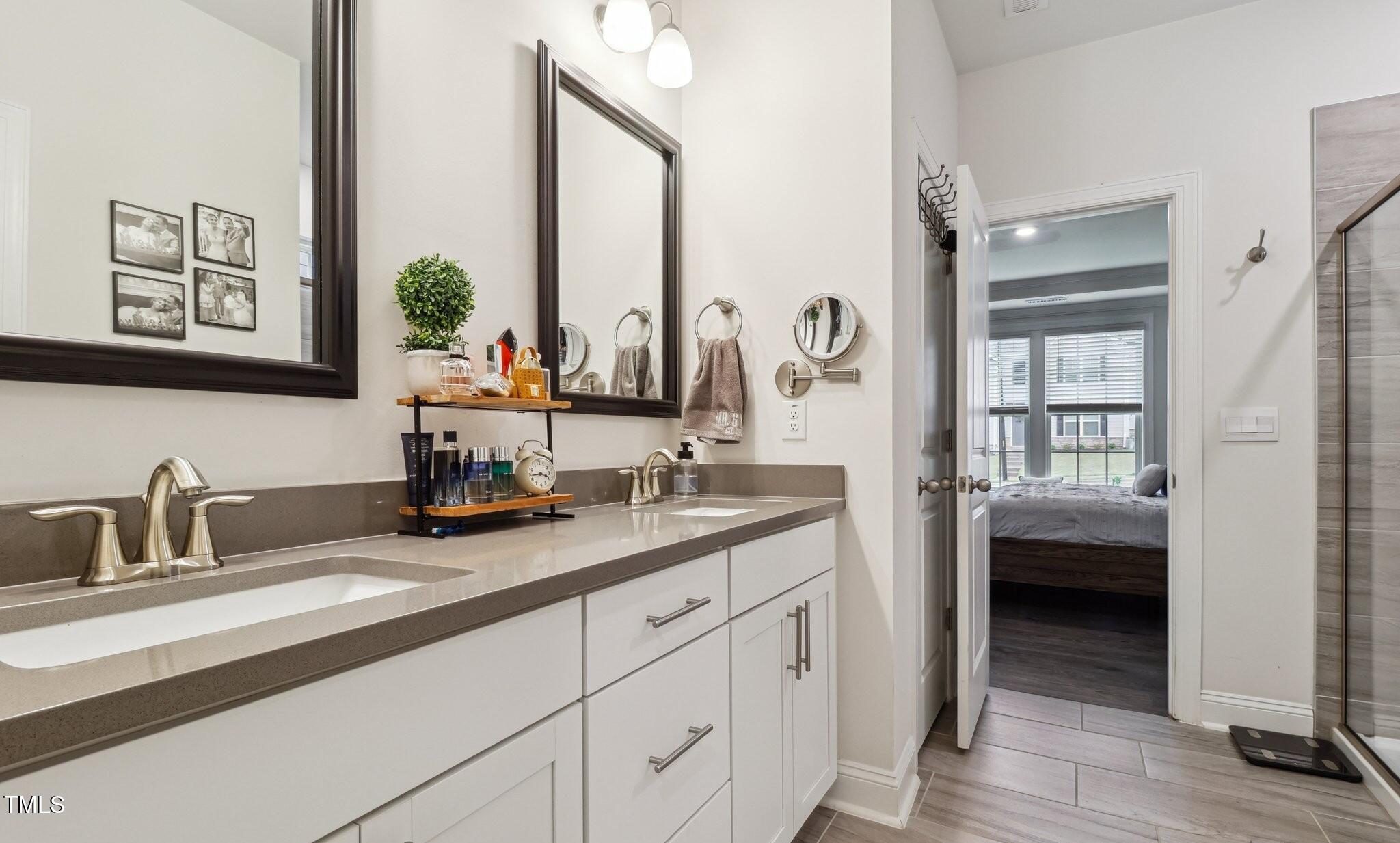 817 James J Freeland Memorial Drive Hillsborough, NC 27278 - Photo 13 of 33 a en suite bathroom with sinks and mirror