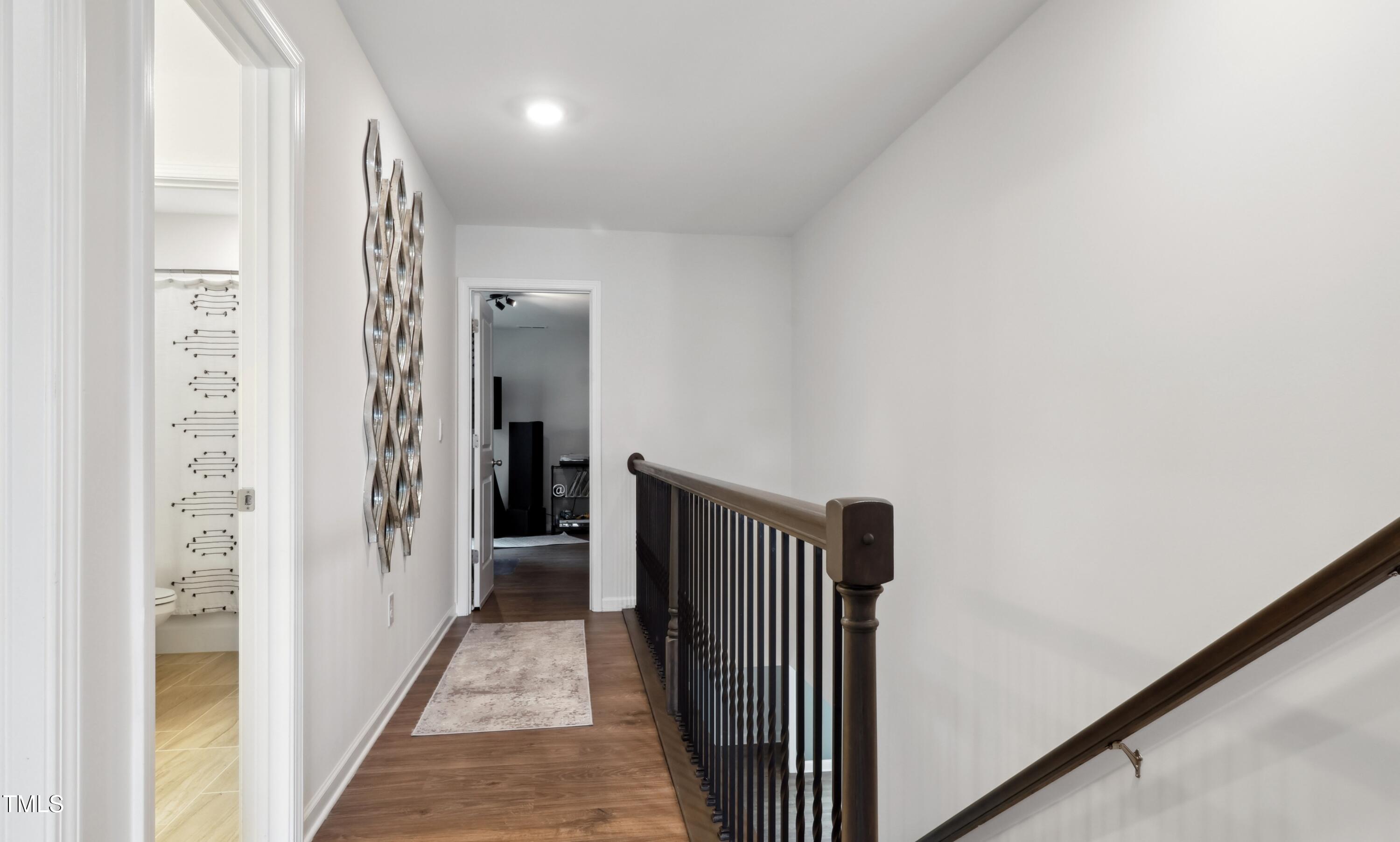 817 James J Freeland Memorial Drive Hillsborough, NC 27278 - Photo 14 of 33 a view of a hallway with wooden floor and staircase