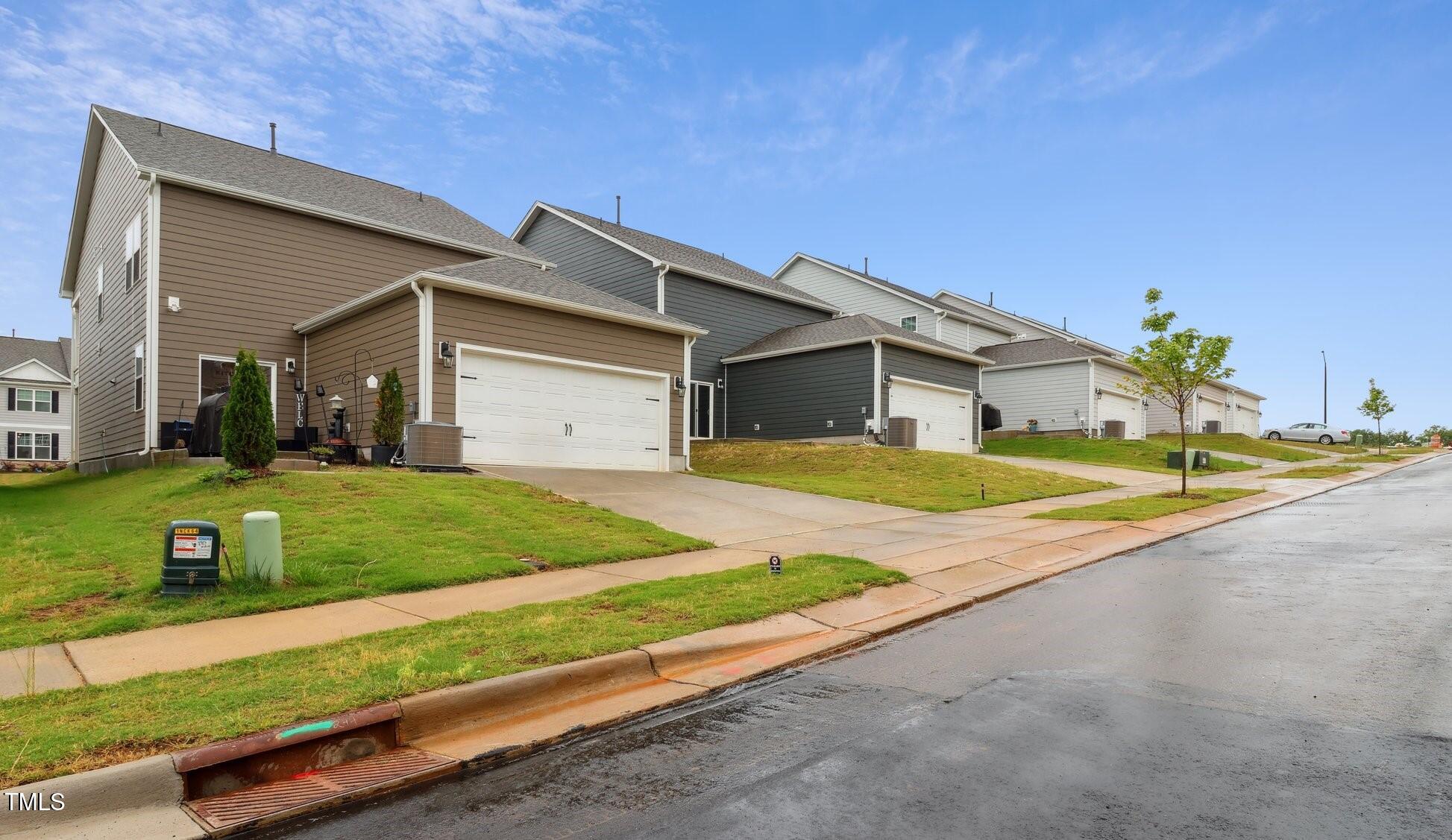 817 James J Freeland Memorial Drive Hillsborough, NC 27278 - Photo 22 of 33 a front view of a house with a yard and garage