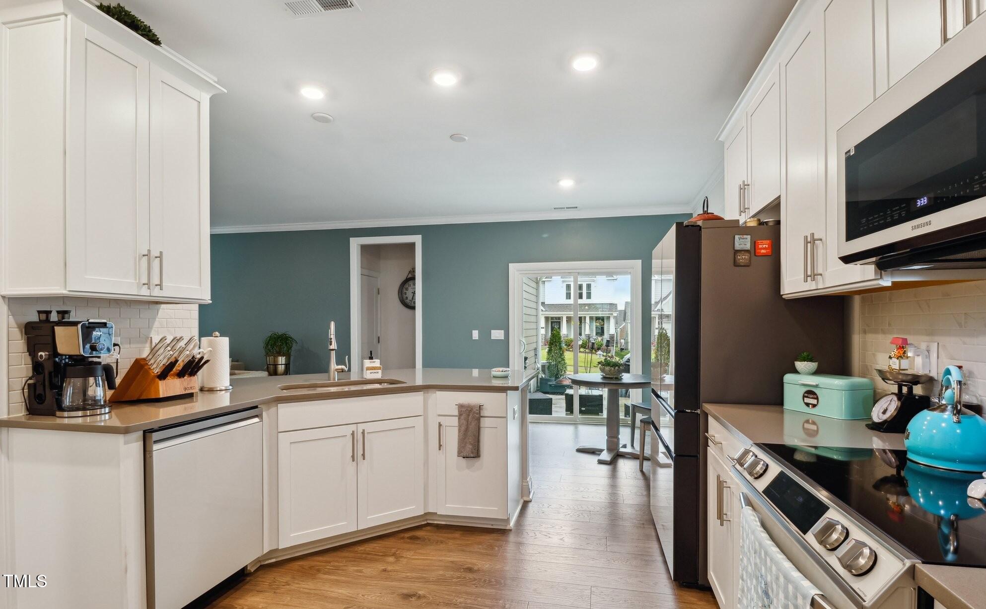 817 James J Freeland Memorial Drive Hillsborough, NC 27278 - Photo 4 of 33 a kitchen with a sink stove and cabinets