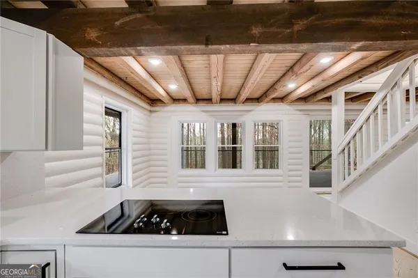 a roof deck with furniture and next to a window