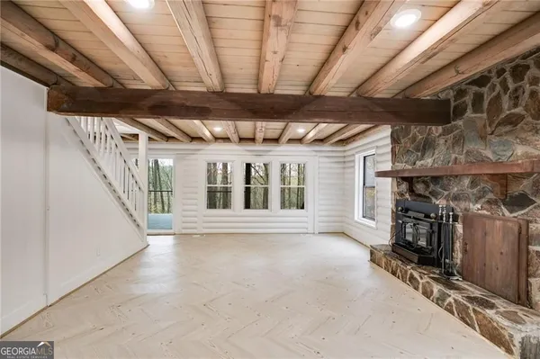 a view of an empty room with wooden floor